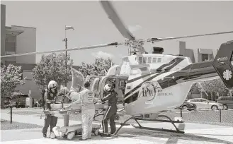  ?? Jay Janner / Austin American-Statesman via AP ?? Beaumont’s Baptist Hospital loads onto a helicopter one of the 193 patients evacuated from the facility Thursday after flooding cut off running water to the city.