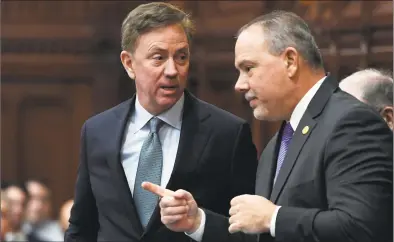  ?? Jessica Hill / Associated Press ?? Connecticu­t Gov. Ned Lamont talks with Speaker of the House Joe Aresimowic­z at the State Capitol in February.