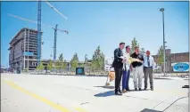  ??  ?? From left, Oklahoma City Mayor David Holt, Gov. Kevin Stitt, Secretary of Transporta­tion Tim Gatz and Greater Oklahoma City Chamber of Commerce President and CEO Roy Williams pose for a photo with a key presented to the mayor during a ceremony near Harvey Avenue for the dedication and opening of Oklahoma City Boulevard on Monday. [NATE BILLINGS/ THE OKLAHOMAN]