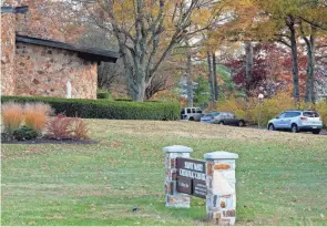  ?? JOSEPH SCHELLER/COLUMBUS DISPATCH ?? A car drives into the parking lot of St. Mary Catholic Church in Groveport prior to Mass on a recent Sunday morning. The church is one of 19 in the diocese that is recommende­d to close as part of the Real Presence, Real Future initiative.