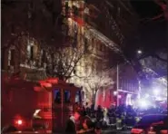  ?? FRANK FRANKLIN II - THE ASSOCIATED PRESS ?? Firefighte­rs respond to a building fire Thursday, in the Bronx borough of New York.