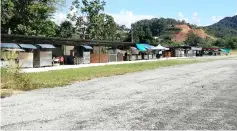  ??  ?? Temporary stalls erected by the Kapit District Council are seen near the disused STOLport runway.