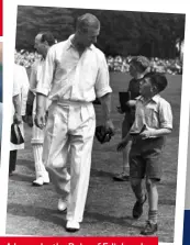  ??  ?? A boy asks the Duke of Edinburgh for his autograph before the start of a charity cricket match.