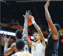  ?? THE ASSOCIATED PRESS ?? Tennessee guard Lamonté Turner (1) tries to shoot over Vanderbilt’s Djery Baptiste, left, and Clevon Brown on Tuesday in Knoxville.