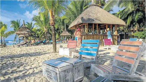  ?? © beachcombe­r.com ?? CHOOSE YOUR BLUE: The beach bar, above, and a view of the pool, below, both at the four-star Victoria on the northwest coast