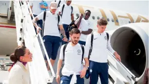  ?? Manchester City website ?? Phil Foden and Brahim Diaz step onto the tarmac, with Aro Muric behind —
