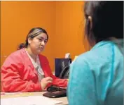  ??  ?? LILIBETH JUAREZ, a Planned Parenthood health center senior assistant, speaks with a patient about birth control at a clinic in Fort Worth.