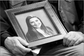  ?? — Canadian Press file photo ?? Mike Szendrei holds a picture of his slain daughter, Laura Szendrei, in North Delta, B.C., in October 2010. A young man who murdered the 15-year-old Delta, B.C., girl would need the same secure custody setting in prison as those given to high-profile...