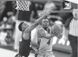  ?? JOHN PETERSON/ASSOCIATED PRESS ?? Creighton guard Shereef Mitchell goes in for a layup against Xavier guard KyKy Tandy during a game on Wednesday in Omaha, Nebraska.