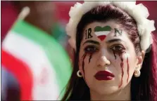  ?? FRANK AUGSTEIN — THE ASSOCIATED PRESS ?? A woman stands on the tribune with her face painted in memory of Mahsa Amini, a woman who died while in police custody in Iran at the age of 22, prior to the World Cup group B soccer match between Wales and Iran, at the Ahmad Bin Ali Stadium in Al Rayyan , Qatar on Friday.