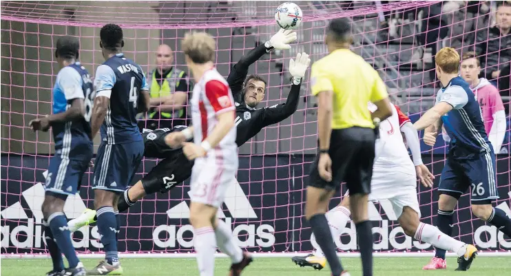  ?? — THE CANADIAN PRESS ?? Whitecaps goalkeeper Stefan Marinovic dives to make a save against the San Jose Earthquake­s during Sunday’s game at B.C. Place Stadium.