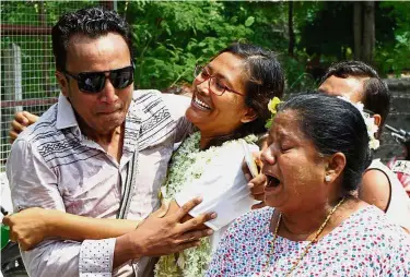  ??  ?? Activist Pwint Phyu Latt (centre) greeting her loved ones after she was released from Oo Bo prison in Mandalay. — AFP Joyful reunion: