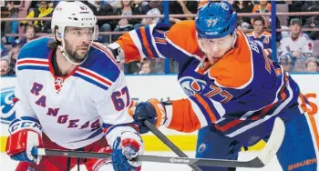  ?? Derek Leung/Gett y Images/File ?? Defenceman Anton Belov, right, says he ‘could have tried to re-sign’ with the Oilers.