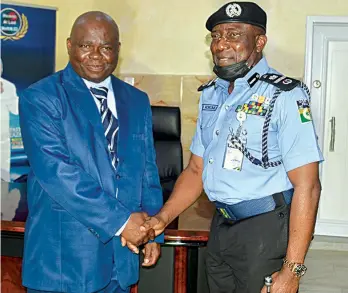  ??  ?? Pastor Lazarus Muoka ( left) in handshake with Assistant Inspector General of Police ( AIG), Zone 2, Johnson Kokumo during the AIG’S visit to the headquarte­rs Church of the Lord’s Chosen in Ijesha, Lagos