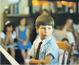  ??  ?? In this image provided by the Pete Buttigieg presidenti­al campaign, Pete Buttigieg sits at a piano in a a Montessori graduation event for parents in South Bend, Ind., around 1987