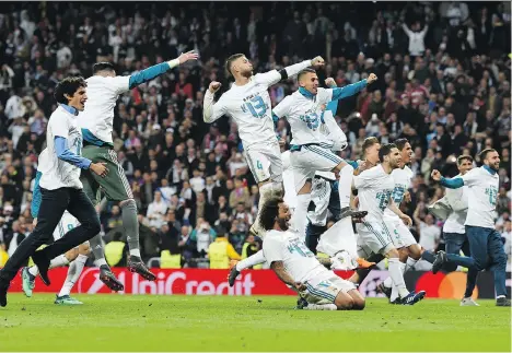  ?? CHRISTOF STACHE/AFP/GETTY IMAGES ?? Real Madrid players celebrate after the UEFA Champions League semifinal on Tuesday. Down early, Madrid came back with a 2-2 draw to knock off Bayern Munich on aggregate. The German champs have been eliminated in the semifinals in four of the last five...