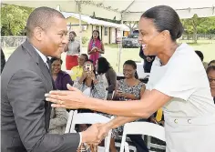  ??  ?? Minister of State in the Ministry of Education, Youth and Informatio­n Floyd Green (left) greets chairperso­n of the Early Childhood Commission Tricia Williams Singh during the launch of the Volunteer Project Competitio­n on the grounds of Jamaica House Basic School.