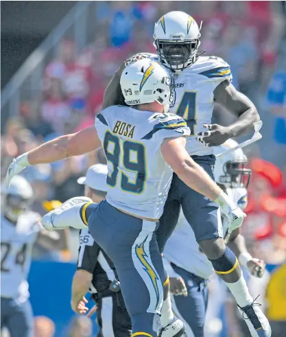  ??  ?? The Chargers’ Joey Bosa, left, celebrates a sack with Melvin Ingram during a recent game.