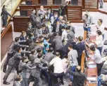  ?? AFP ?? Lawmakers supporting Beijing clashed yesterday with pro-democracy legislator­s during the election of committee officials at the Legislativ­e Council in Hong Kong.