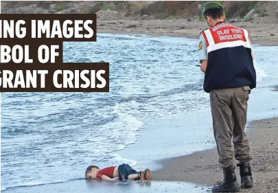  ?? AFP/GETTY IMAGES ?? A Turkish police officer stands next to a migrant child’s body off the shores of Bodrum in southern Turkey on Wednesday.