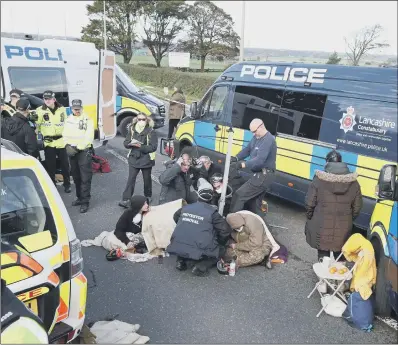  ??  ?? A police team deals with protesters at Cuadrilla’s site in Lancashire.