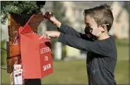  ?? BEN HASTY —MEDIANEWS GROUP PHOTO ?? Park Parsons, 6, checks the mailbox for Letters to Santa at his family’s home in Exeter Township.