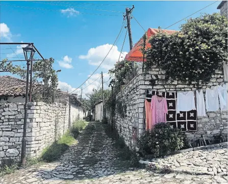  ?? MARY WINSTON NICKLIN FOR THE WASHINGTON POST ?? Lording over the town of Berat, the ancient hilltop “Kala” (castle) is still home to a thriving neighbourh­ood population within its walled fortificat­ions.