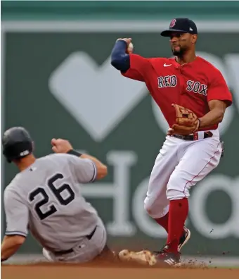 ?? StUart cahILL / heraLd StaFF FILe; BeLoW Matt StoNe / heraLd StaFF FILe ?? POSITIONED WELL: Xander Bogaerts appears set to stay at shortstop this season despite the Red Sox signing fellow star infielder Trevor Story. Meanwhile, Kiké Hernandez, below, should settle into regular duty in center field.
