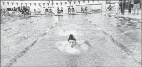  ??  ?? Above left: A group of swimmers prepares to run through a warm-up round last weekend in Pecos. Above right: A Big Spring swimmer makes their way through the pool during the butterfly race. Big Spring boys won the meet while the Lady Steers finished second. By SHAWN MORAN