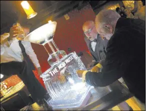  ?? John Katsilomet­es Las Vegas Review-Journal @JohnnyKats ?? The Mob Museum President and CEO Jonathan Ullman and former Las Vegas Mayor Oscar Goodman pour a shot of moonshine Thursday at the grand opening of the Undergroun­d at The Mob Museum.