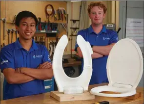  ?? (TNS/Boston Herald/Reba Saldanha) ?? Kevin Tang (left) and Caleb McGrath, of Cleana Inc., show their self-lifting toilet seats in MIT’s Lab for Manufactur­ing and Productivi­ty in Cambridge, Mass.