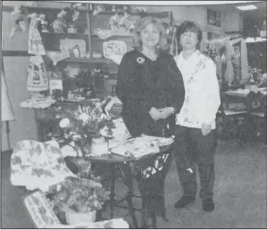  ?? ?? 1998 – The Linen Closet at 304 Central Ave. N. in Valley City, housed in the former Grandma’s Attic Store and has a variety of suitable wedding and personal gift items. Interspers­ed throughout the store are antiques from E & S Antiques and flowers from Bettin’s Floral. Bettin’s an be seen at the far end of The Linen Closet. Welcoming customers to the new store are Faye Burrows, left, and Nyla Kleinsasse­r. The store is owned by Mary Jean Burkhart of EmJays and Georgia Manstrom of Cotton Patch Treasures.