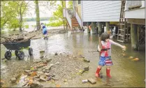  ?? Matthew Hinton / Associated Press ?? Delilah Campbell, 4, right, and her sister, Tallulah Campbell, 8, clear driftwood and other debris in preparatio­n of Tropical Storm Barry near New Orleans on Thursday.