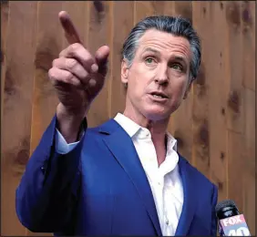  ?? RICH PEDRONCELL­I / AP FILE PHOTO (2022) ?? California Gov. Gavin Newsom speaks with reporters Oct. 7 in Sacramento, Calif. Gay rights advocates are calling for Newsom to issue more pardons and for broader clemency actions for LGBTQ people in prison.