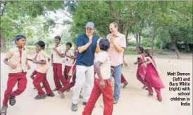  ??  ?? Matt Damon (left) and Gary White (right) with school children in India