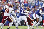  ?? ADRIAN KRAUS — THE ASSOCIATED PRESS ?? Washington Football Team’s Kamren Curl (31) hits Buffalo Bills quarterbac­k Josh Allen (17) who throws a pass during the second half of an NFL football game Sunday, Sept. 26, 2021, in Orchard Park, N.Y.