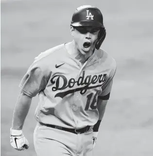  ?? TOM PENNINGTON/GETTY-AFP ?? The Dodgers’ Will Smith celebrates his three-run homer against the Braves in Friday night’s Game 5.