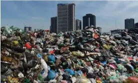  ?? Photograph: Nhac Nguyen/AFP/ Getty Images ?? Waste piles up at a temporary dumpsite near high rise buildings in downtown Hanoi. Methane gas is released from decomposin­g organic waste.