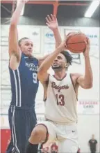  ??  ?? BOB TYMCZYSZYN ST. CATHARINES STANDARD Brock’s Dani Elgadi (13), shown driving past past Ryerson’s Adam Voll (9) in the OUA men’s basketball semfinals, has a chance to end the 2017-18 with a Canadian championsh­ip after the Badgers received a wild-card...