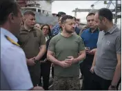  ?? UKRAINIAN GOVERNMENT — FOR THE ASSOCIATED PRESS ?? In this photo provided by the Ukrainians­e, Ukrainian President Volodymyr Zelenskyy, center, is surrounded by ambassador­s of different countries and UN officials, as they visit a port in Chornomork loading of grain on a Turkish ship Friday.