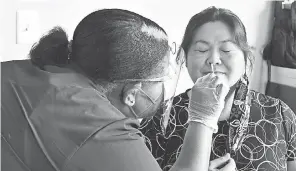  ?? MALCOLM DENEMARK/ USA TODAY NETWORK ?? Cindy Yee of Titusville, Fla., gets a COVID- 19 test from a nurse at the Faith Temple Christian Center in Rockledge.