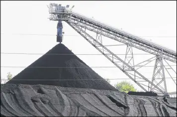  ?? NATI HARNIK / AP 2014 ?? A hill of coal awaits burning at the North Omaha power station in Omaha, Neb. At the Trump administra­tion’s request, a federal appeals court agreed Friday to postpone a ruling on lawsuits challengin­g restrictio­ns on carbon emissions.