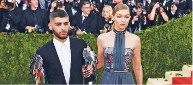  ?? File / Agence France-presse ?? ↑
Gigi Hadid (right) and Zayn Malik arrive for the Costume Institute Benefit at The Metropolit­an Museum of Art in New York.