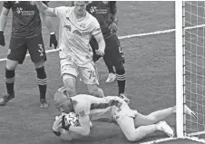  ?? ADAM CAIRNS/COLUMBUS DISPATCH ?? Crew goalkeeper Eloy Room makes a save in front of Red Bulls forward Tom Barlow during the first half.