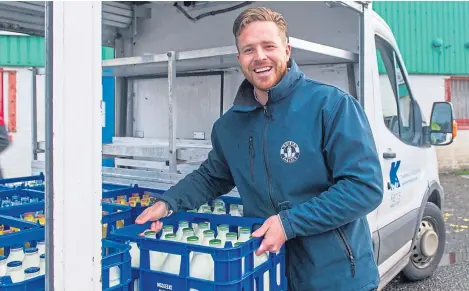  ??  ?? Kelvin Kerr with a crate of glass milk bottles which have seen a surge in demand.