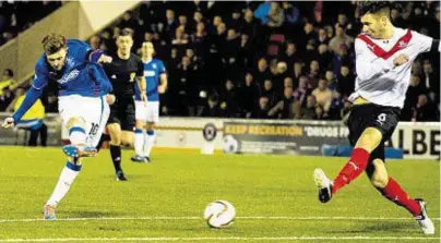  ??  ?? NET-BOUND: Lewis Macleod, left, fires home for Rangers in the 18th minute