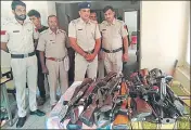  ?? HT PHOTO ?? Police personnel with the licensed weapons deposited by the dera management on Monday.
