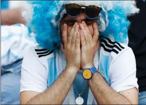  ?? AP/DAVID VINCENT ?? An Argentina fan reacts after the team was eliminated from the World Cup after Saturday’s 4-3 loss to France.