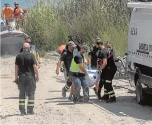  ?? // RAFAEL CARMONA ?? Los bomberos al sacar el cuerpo del pantano