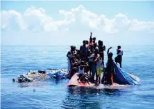  ?? AFP PHOTO ?? STRANDED AT SEA
Rohingya refugees wait to be rescued from the hull of their capsized boat as a vessel from Indonesia’s national search and rescue agency approaches them in waters some 16 nautical miles (29 kilometers) off western Aceh province on Thursday, March 21, 2024.